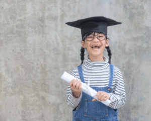 Young bilingual girl wearing a graduation cap and holding a diploma
