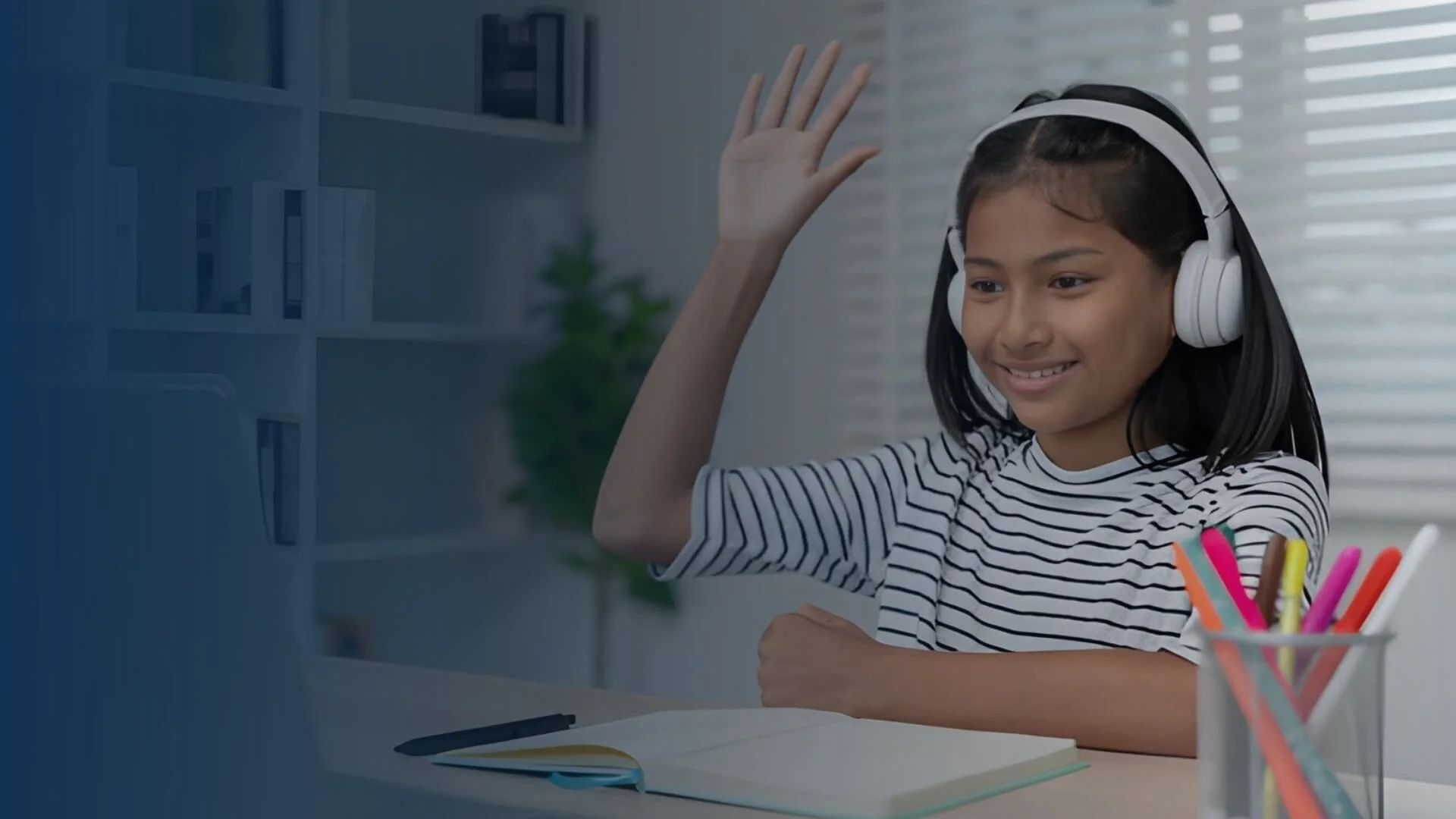 Student in headphones waving during an online bilingual tutoring session on a laptop