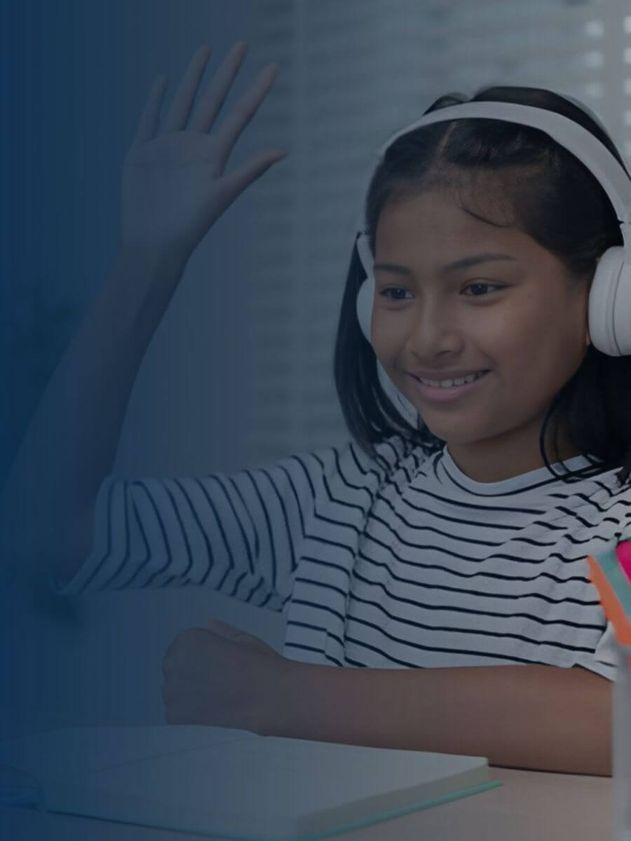 A student joins a live online bilingual tutoring session from home, waving to a certified bilingual tutor at the start of class. Bilingual Bridges delivers personalized reading, math, and world language lessons to K-12 students and adult learners.